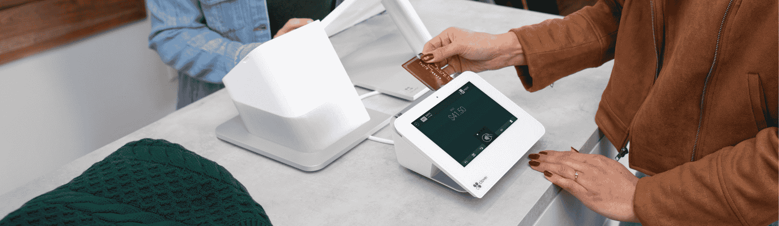 A person is using a tablet to pay for something.