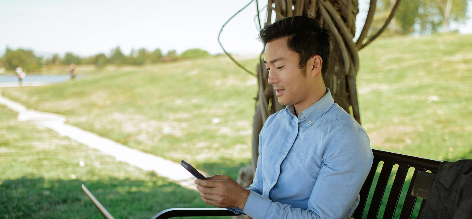Man using his smartphone at a park