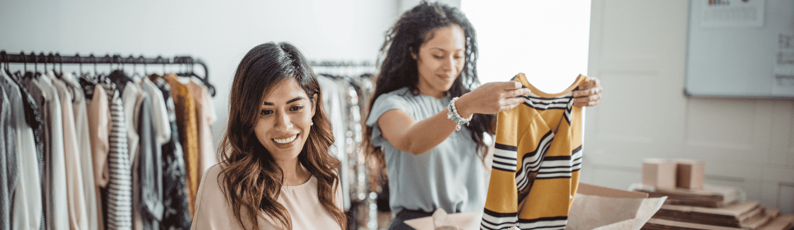 Working women at their store. They are wearing casual clothing, accepting new orders online.