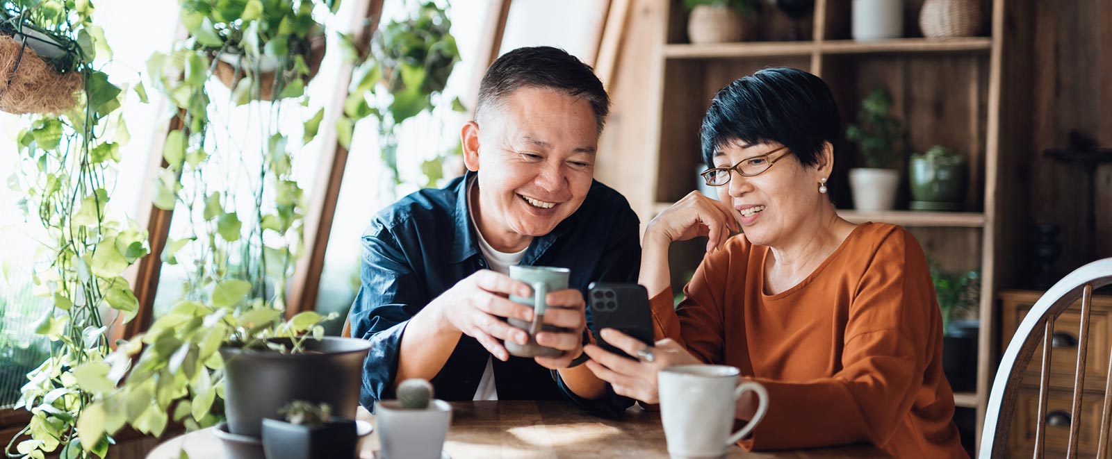 Couple using a smartphone in their home