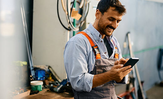 Man in a small business using his smartphone